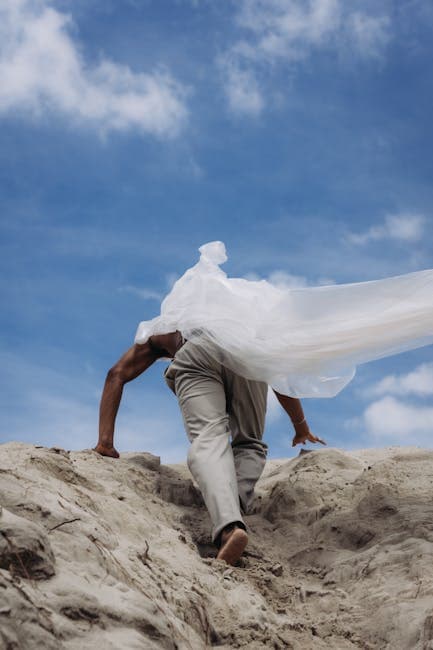 Man in a Raincoat Climbing a Mountain 