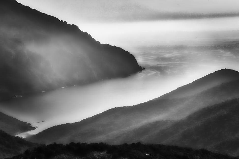 Black and white photo of foggy mountains