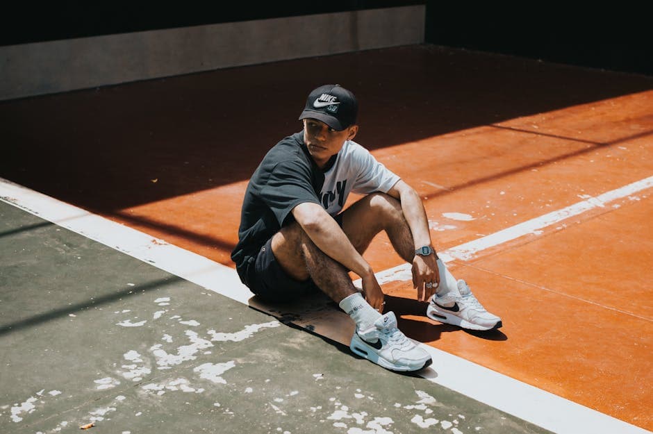 A man sitting on the ground with his sneakers