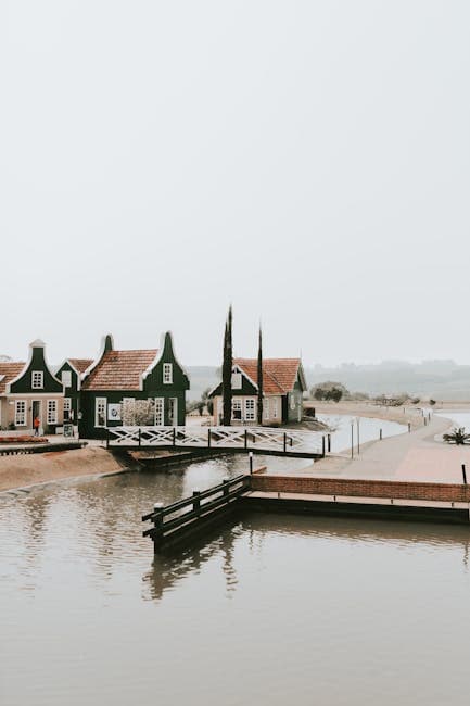 A boat is docked at a dock near a small town