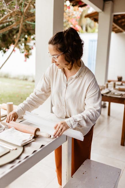 A woman is making a pottery piece