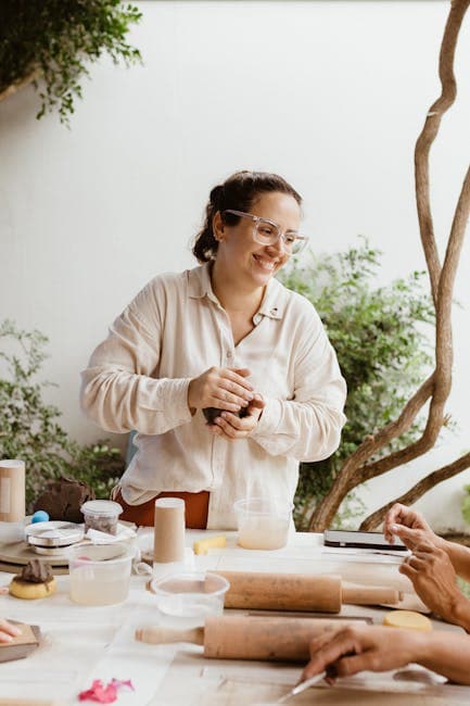 A woman making clay pots at a table