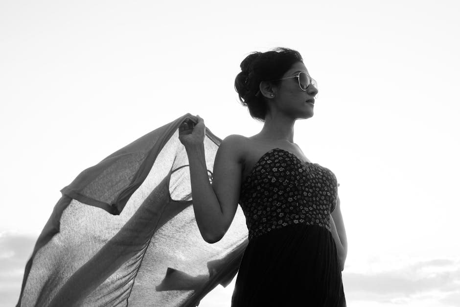 A woman in a dress is standing on a beach