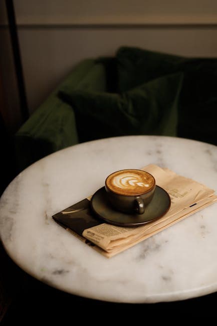 A coffee cup on a table with a white marble top