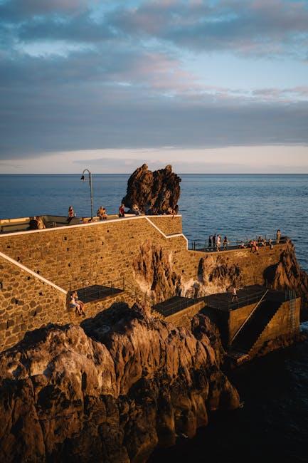 A lighthouse on the coast with people on it