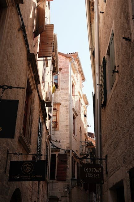 A narrow alley with a sign on it