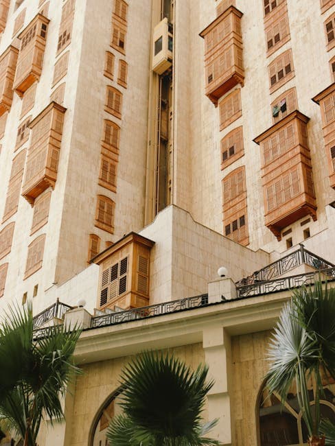 The building has many windows and palm trees