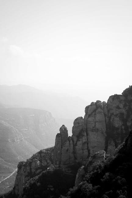 Black and white photo of mountains with clouds