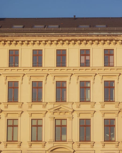 A building with many windows and a clock on the side