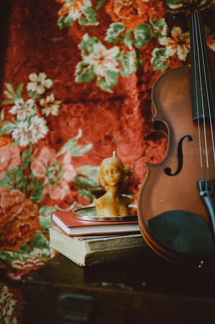 Violin near Wax Candle on Books