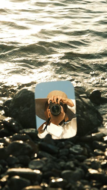 A person taking a photo of the ocean