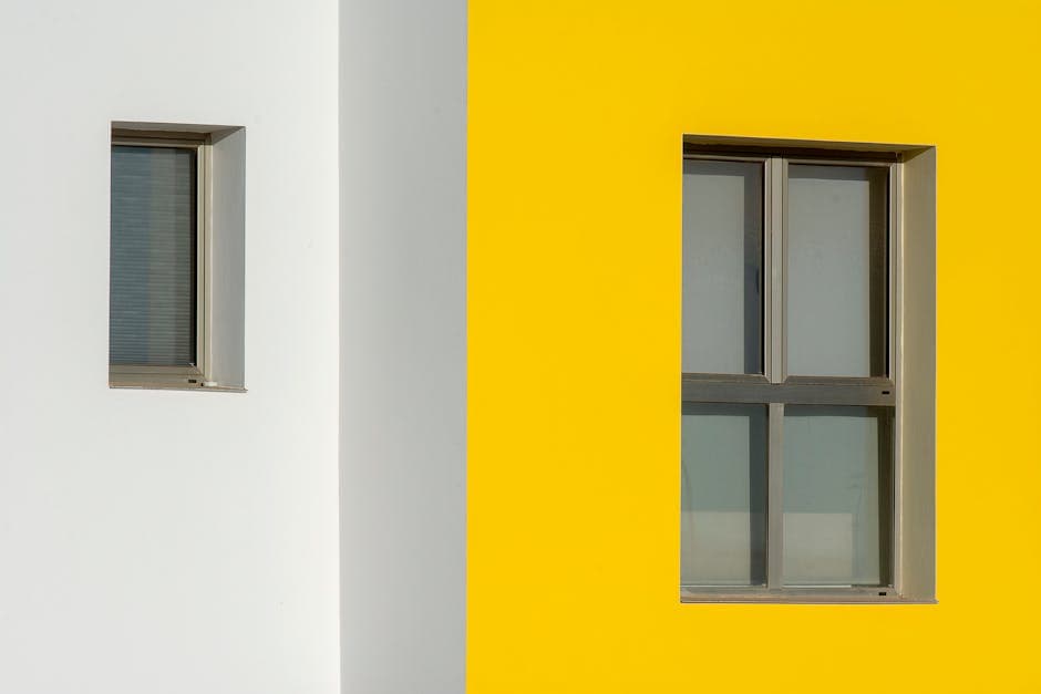 Two windows with yellow and white paint on the side