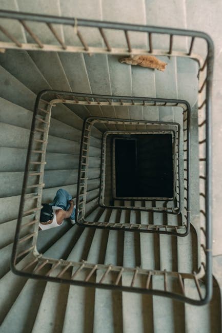 A person is sitting on the stairs of a building