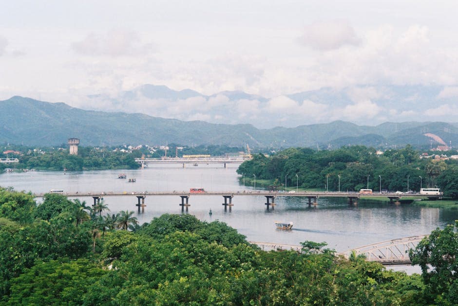 A view of a bridge over a river and mountains