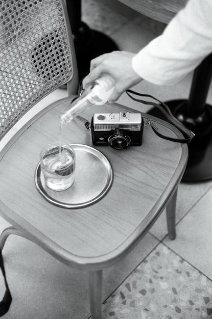 A person pouring liquid into a glass on a chair