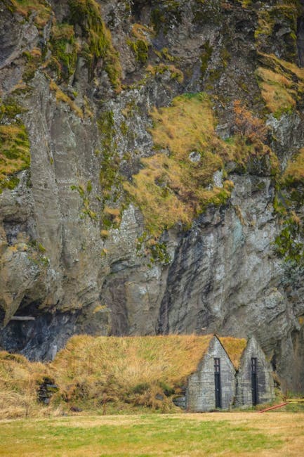 A small church sits in front of a cliff