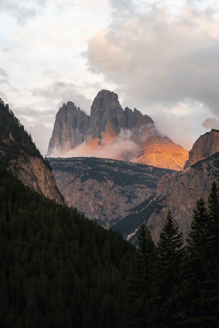 The sun is setting over a mountain range