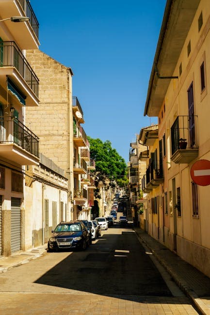 A narrow street with cars parked on both sides