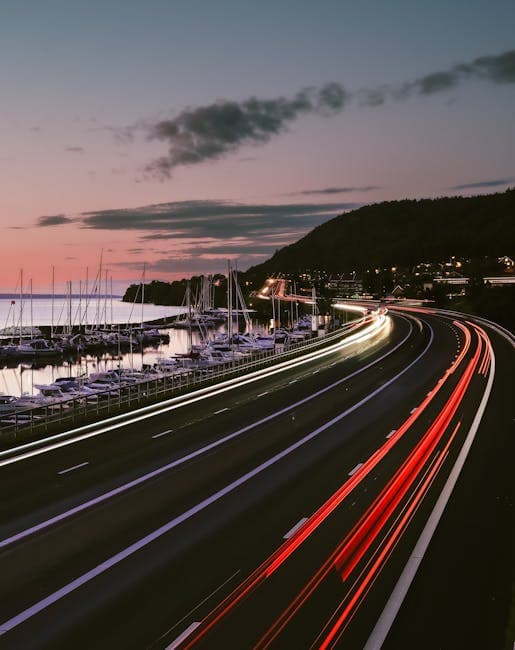 A long exposure photograph of a highway with boats