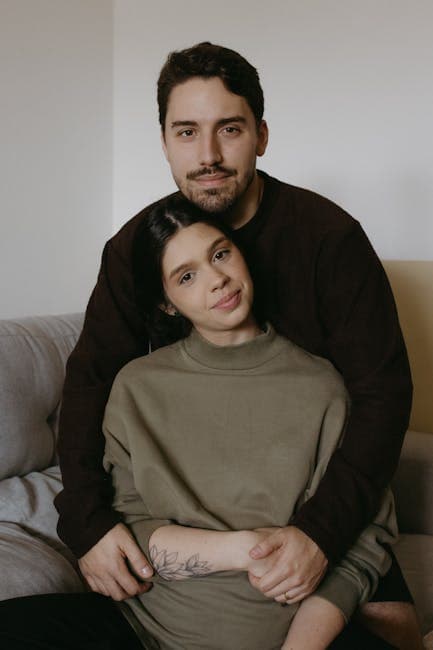 A man and woman sitting on a couch together