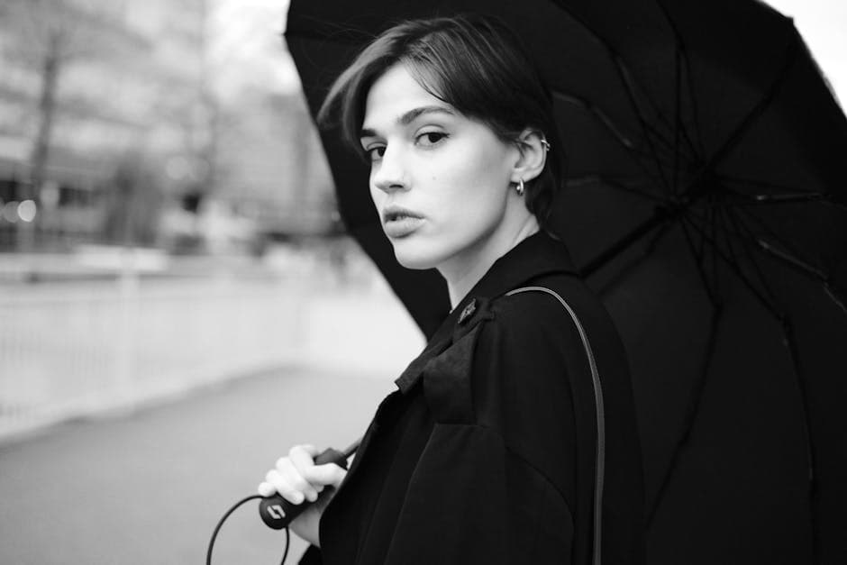 A woman with an umbrella in black and white