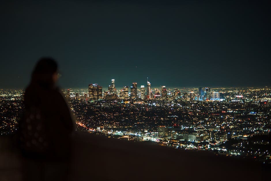 Women overlooking city at night