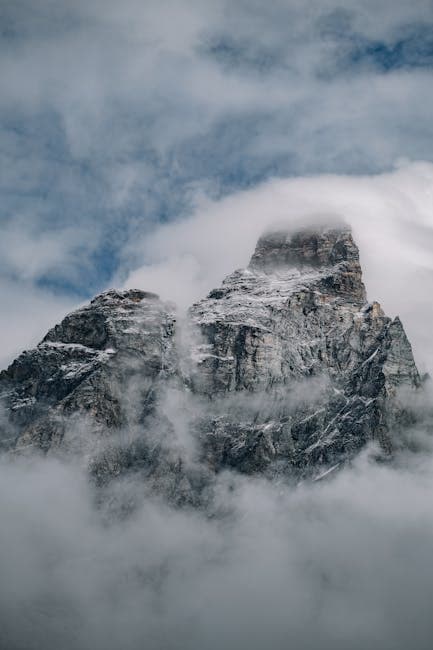 A mountain covered in clouds and fog