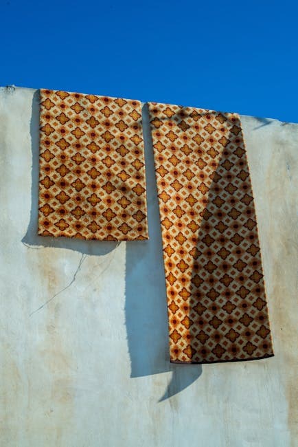 Two pieces of fabric hanging on a wall