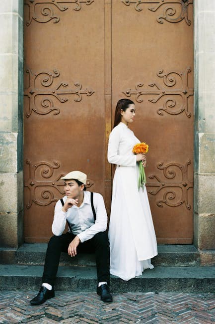 Models in Retro Style Clothes Posing in Front of a Metal Gate