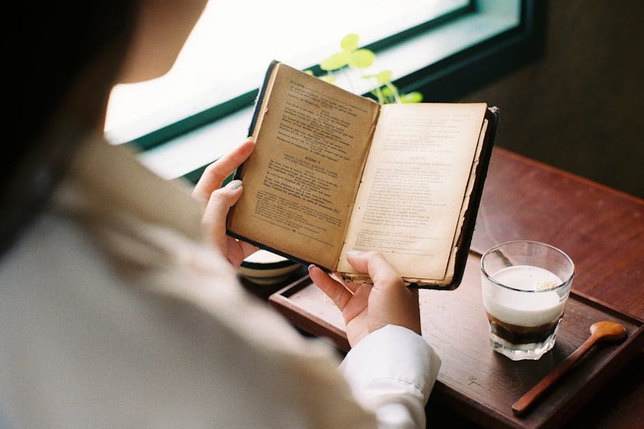 Woman Reading Book at Cafe