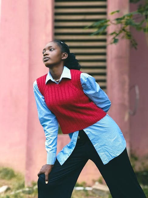 Photo of a Fashionable, Young Woman Posing by the Wall