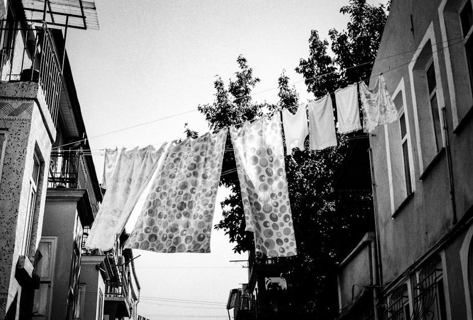 A black and white photo of clothes hanging on a line