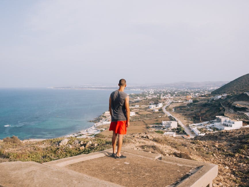 Man Standing on Rooftop over Sea Coast