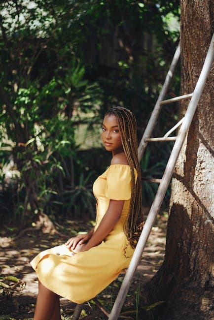 Model in Yellow Off-the-Shoulder Dress Sitting on a Ladder