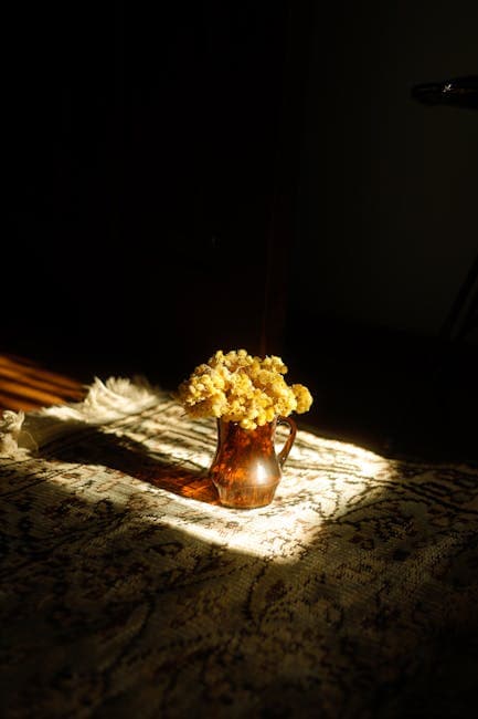 Yellow Flowers in Brown Glass on Carpet