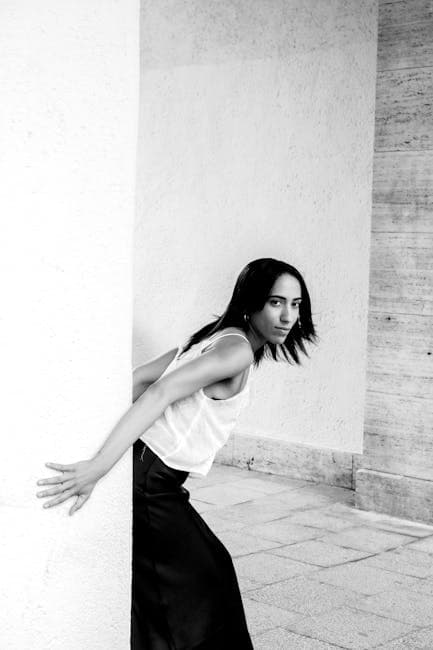 Black and White Shot of a Woman in a Courtyard