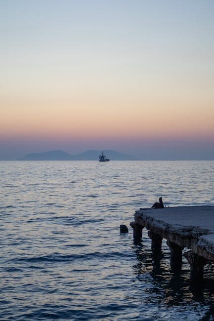 Ship on Sea Coast at Sunset