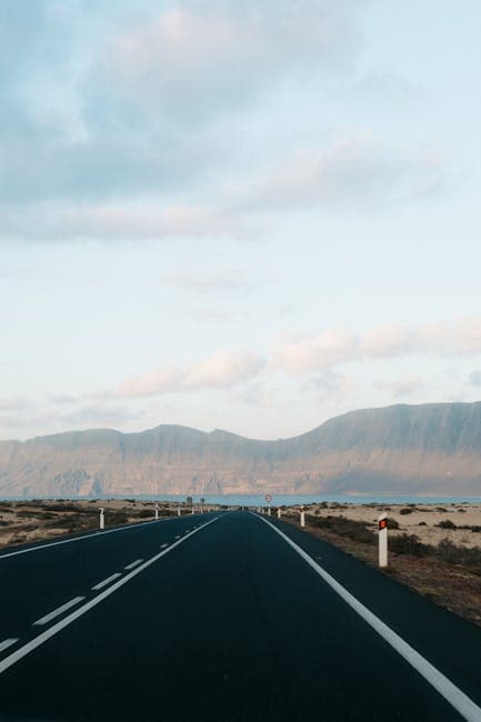 View of an Empty Asphalt Road with Mountains in the Distance 