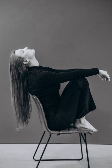 Long-Haired Woman Sitting on a Chair Barefoot