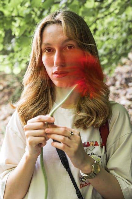 A woman holding a flower in her hand