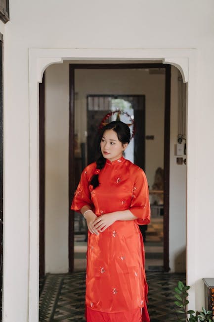 A Young Woman Wearing a Traditional Red Dress Standing in the Hallway 