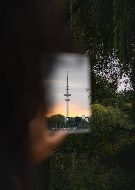 A person holding up a photo of the tv tower