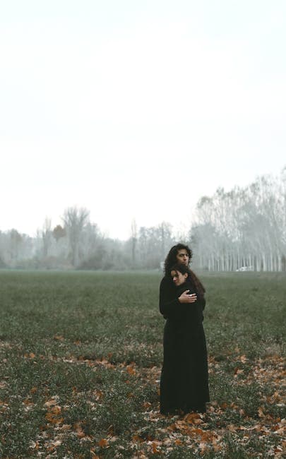 Couple Hugging on Field under Fog