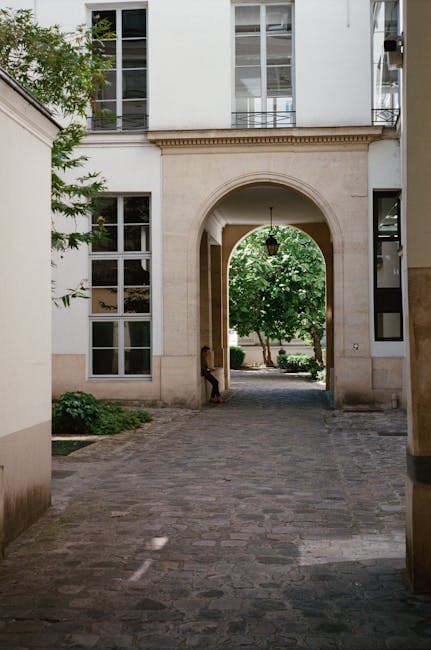 Serene Urban Courtyard with Archway and Foliage