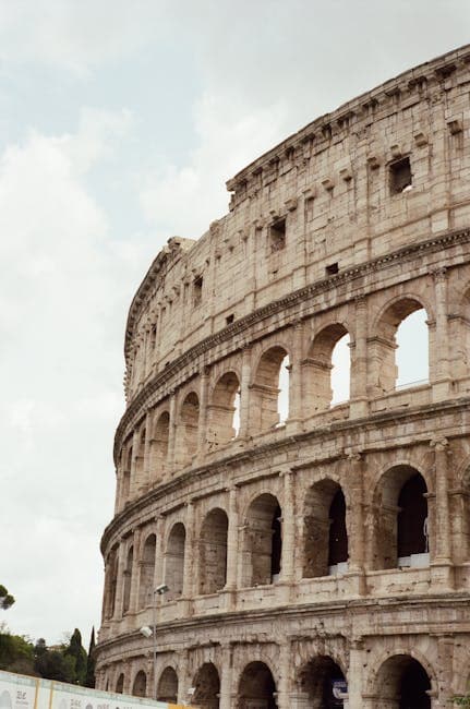 The Majestic Colosseum in Rome Under Cloudy Skies