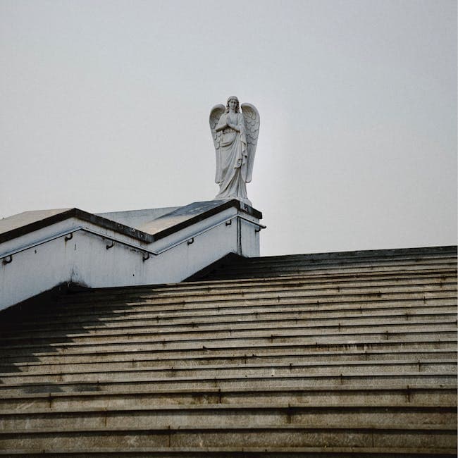 A statue on top of a roof with a white roof