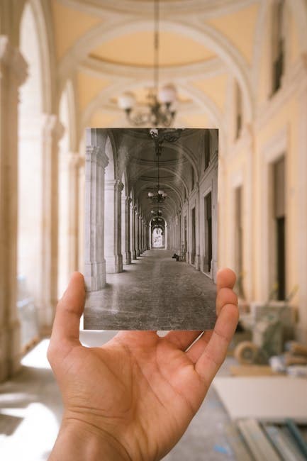 Hand Holding Photo in Historic Corridor Setting