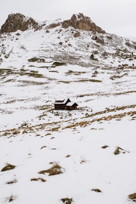 Snowy Mountain Landscape with Wooden Cabin