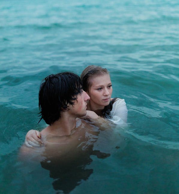 Young Couple Embracing in Serene Ocean Waters