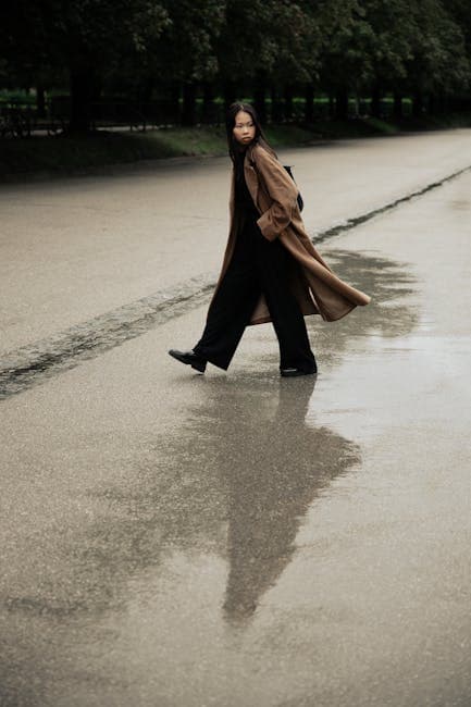 Woman Walking on Rainy Street with Reflection